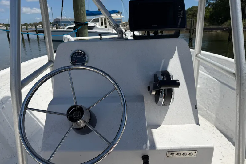 Slide: The Image of Center console of a 2002 Sea Chaser 2100 CC boat with steering wheel and controls. - 16
