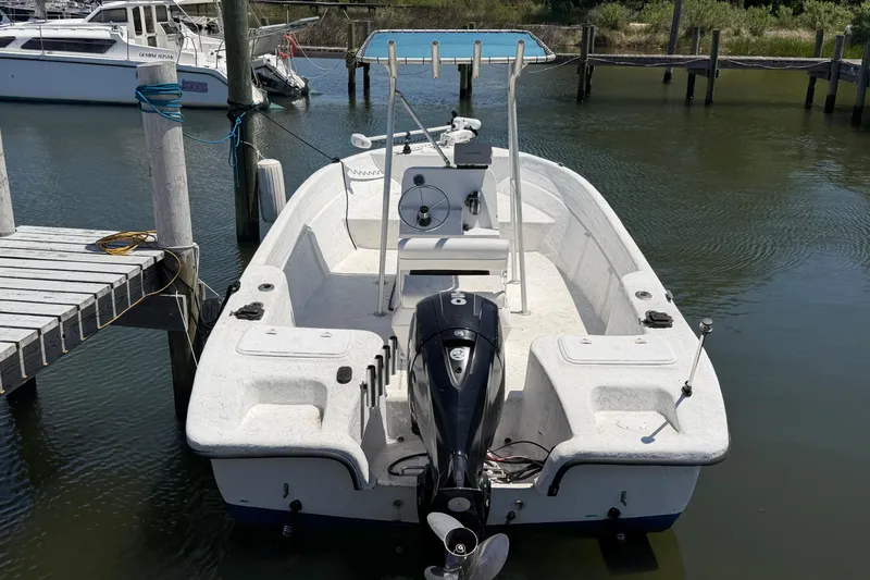 Slide: The Image of 2002 Sea Chaser 2100 CC boat docked in a marina, rear view. - 2