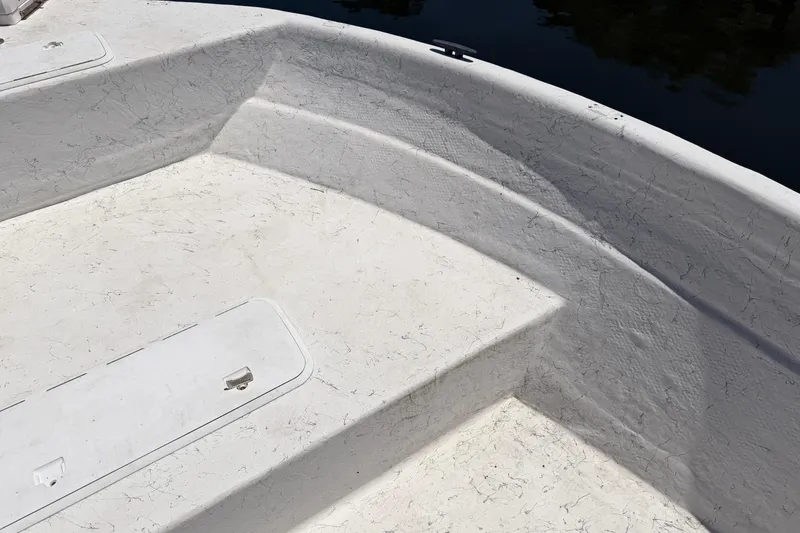 Slide: The Image of Interior view of a 2002 Sea Chaser 2100 CC boat, showcasing white textured surfaces. - 23
