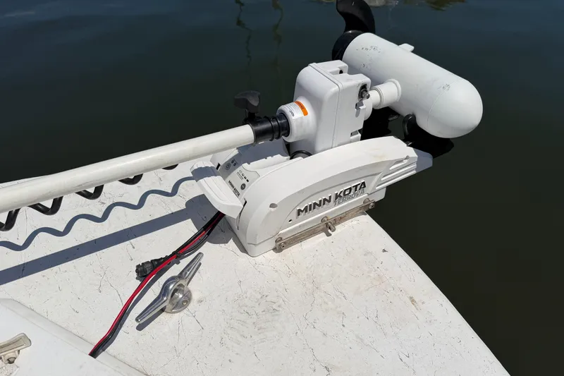 Slide: The Image of Minn Kota trolling motor on 2002 Sea Chaser 2100 CC boat, docked on calm water. - 24