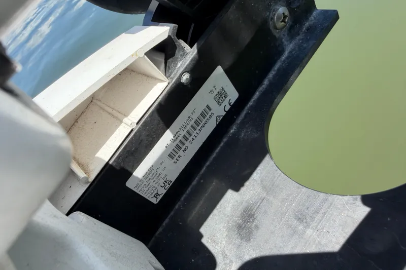 Slide: The Image of Close-up of a Sea Chaser 2100 CC 2002 boat's identification label near water. - 25