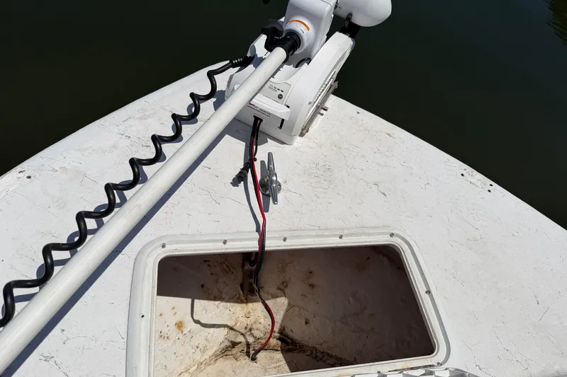 Slide: The Image of Bow of a 2002 Sea Chaser 2100 CC with trolling motor and open storage compartment. - 26