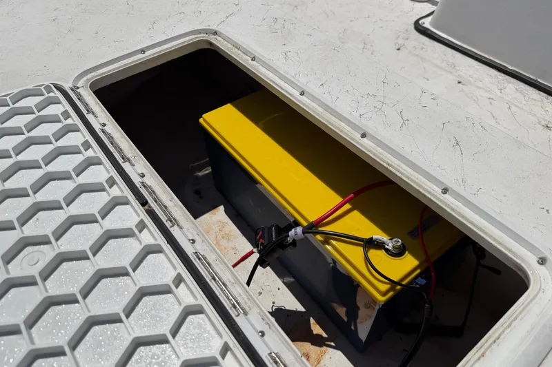 Slide: The Image of Battery compartment of a 2002 Sea Chaser 2100 CC boat with yellow battery. - 28