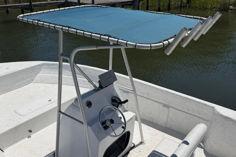 Slide: The Image of 2002 Sea Chaser 2100 CC boat with T-top and steering console on calm water. - 5