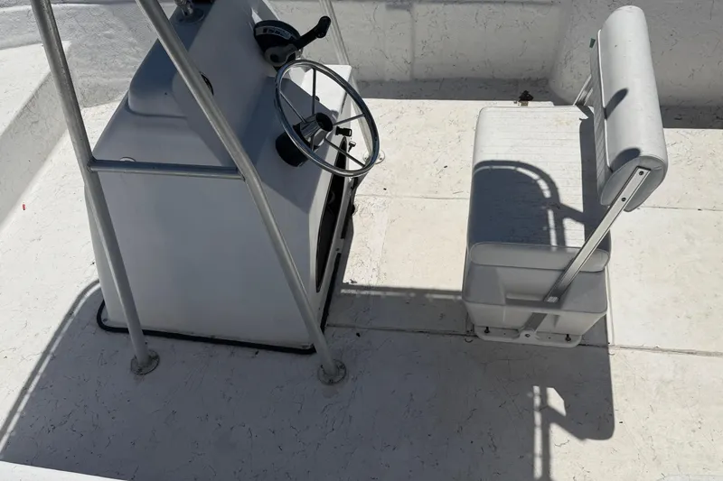 Slide: The Image of 2002 Sea Chaser 2100 CC boat interior with steering console and seating. - 8