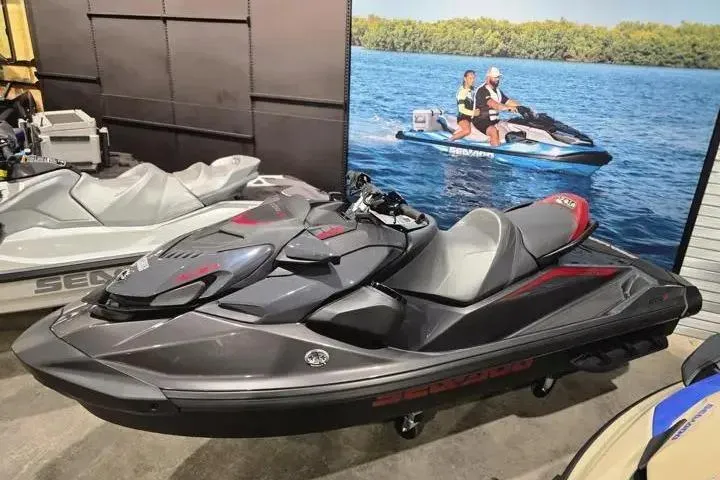 Slide: The Image of 2026 Sea-Doo GTR-X 300 jet ski displayed in showroom with promotional backdrop. - 4
