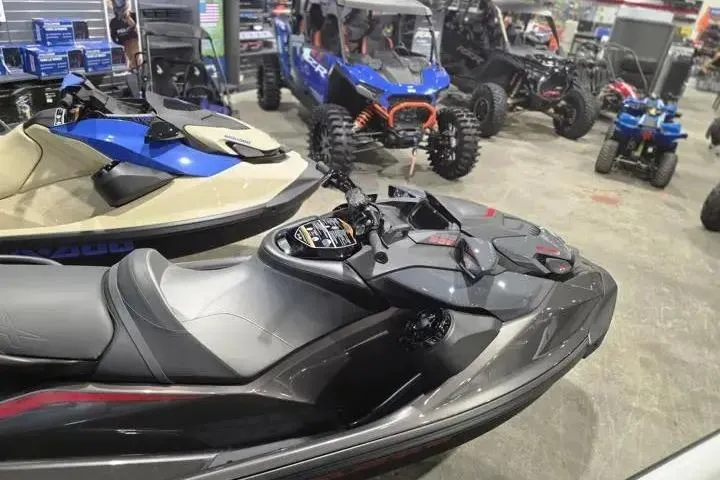 Slide: The Image of 2026 Sea-Doo GTR-X 300 jet ski displayed in a showroom with off-road vehicles. - 8