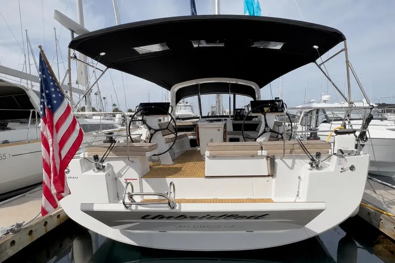 The Image of 2023 Beneteau Oceanis 51.1 yacht docked, featuring spacious deck and American flag. - 0