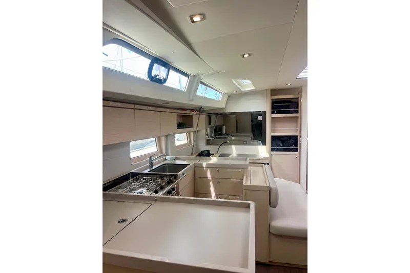 Slide: The Image of Interior of 2023 Beneteau Oceanis 51.1 yacht, featuring modern kitchen and seating area. - 10