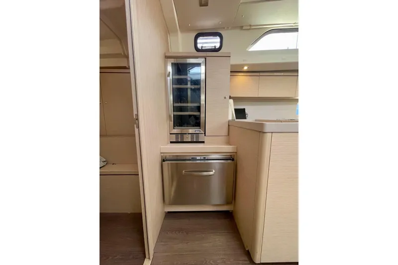 Slide: The Image of Modern kitchen area in 2023 Beneteau Oceanis 51.1 yacht, featuring sleek cabinetry and appliances. - 12