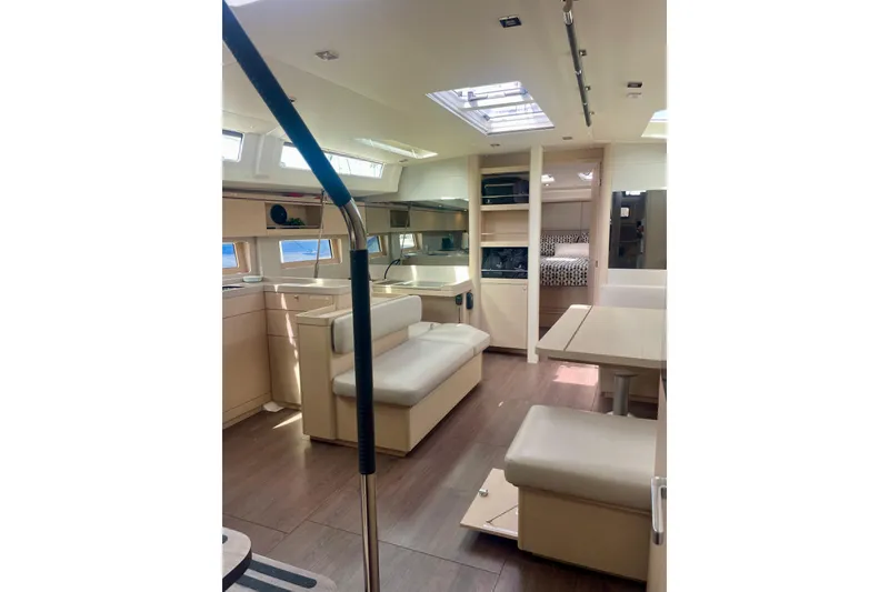 Slide: The Image of Interior of 2023 Beneteau Oceanis 51.1 yacht, featuring modern seating and dining area. - 13