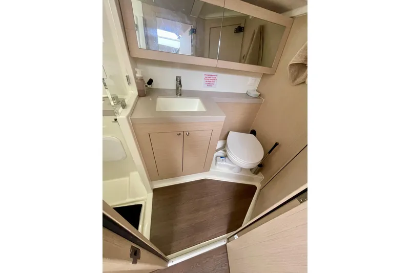 Slide: The Image of Modern bathroom in 2023 Beneteau Oceanis 51.1 yacht with sink, toilet, and mirror. - 15