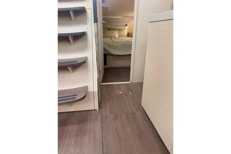 Slide: The Image of Interior view of 2023 Beneteau Oceanis 51.1 yacht, featuring wooden flooring and cozy cabin. - 16