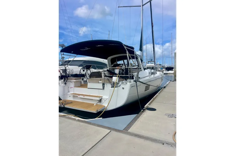Slide: The Image of 2023 Beneteau Oceanis 51.1 yacht docked at marina under blue sky. - 3
