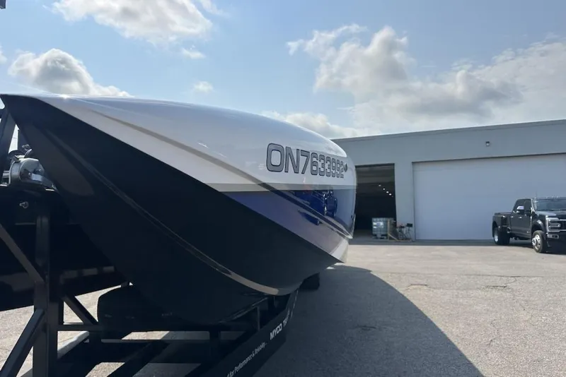 Slide: The Image of 2018 Wright Performance 420 boat on trailer, parked outside a garage under a cloudy sky. - 14