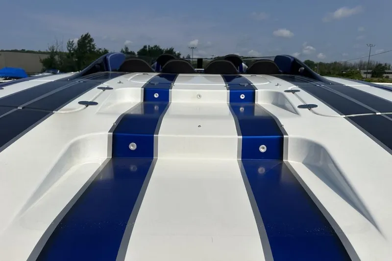 Slide: The Image of 2018 Wright Performance 420 boat with sleek blue and white design, viewed from the rear. - 20