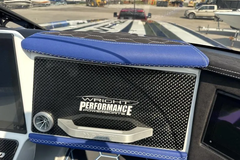 Slide: The Image of 2018 Wright Performance 420 dashboard with carbon fiber panel and blue leather accents. - 37