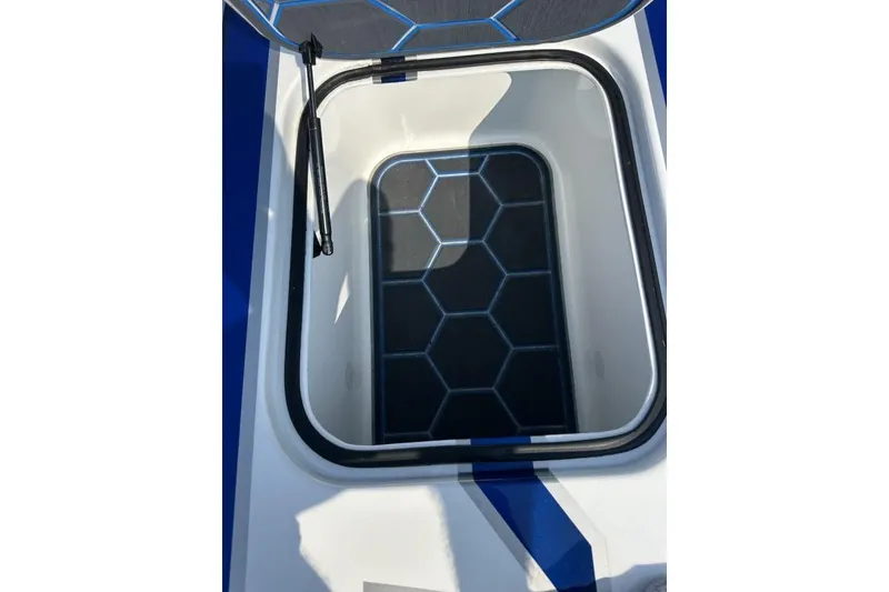 Slide: The Image of Open storage compartment on 2018 Wright Performance 420 boat with hexagonal pattern interior. - 53