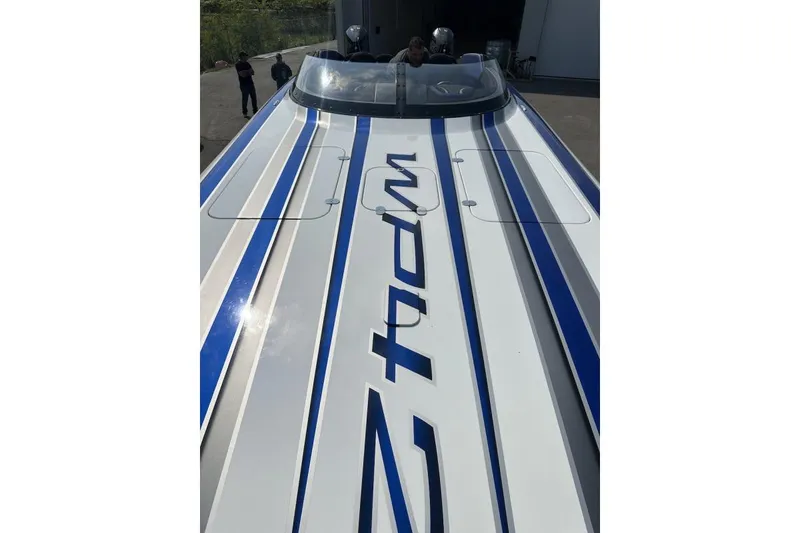 Slide: The Image of 2018 Wright Performance 420 boat with blue and white stripes, docked outdoors. - 56