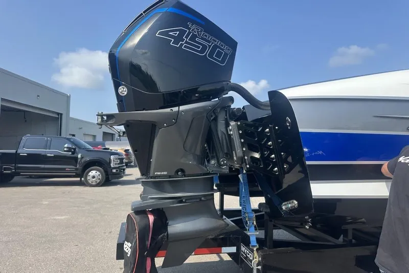 Slide: The Image of Outboard motor on Wright Performance 420 boat, 2018 model, in a parking area. - 63