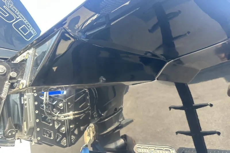 Slide: The Image of Close-up of a 2018 Wright Performance 420 boat's sleek black hull and engine components. - 64