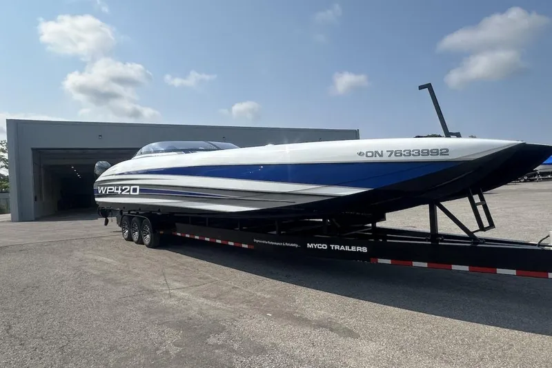 Slide: The Image of 2018 Wright Performance 420 boat on trailer outside a garage under a clear sky. - 70