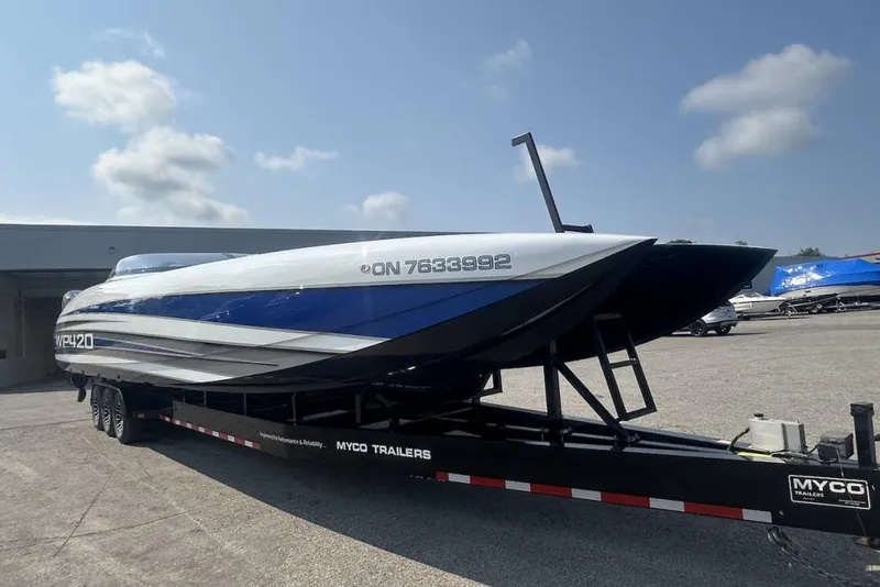 Slide: The Image of 2018 Wright Performance 420 boat on Myco trailer, parked outdoors under a clear sky. - 71