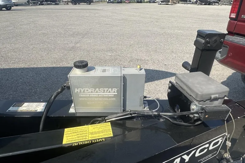 Slide: The Image of HydraStar trailer brake actuator on Wright Performance 420, 2018 model, in a parking lot. - 76