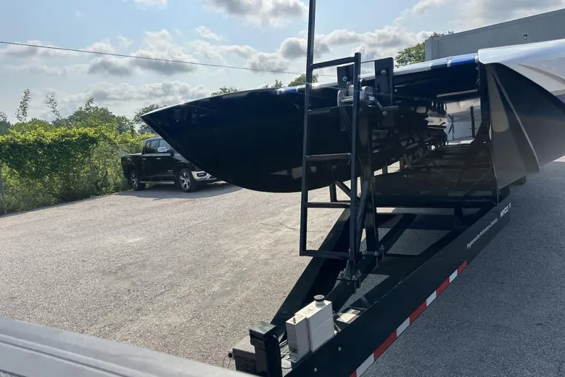 Slide: The Image of 2018 Wright Performance 420 boat on trailer, parked outdoors under a cloudy sky. - 9