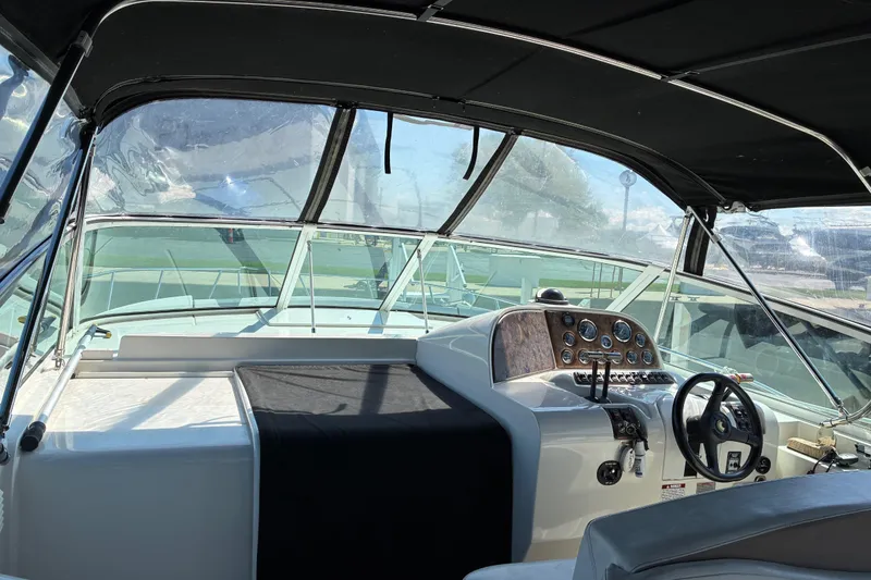 Slide: The Image of 1999 Trojan 360 Express boat cockpit with steering wheel and control panel. - 11