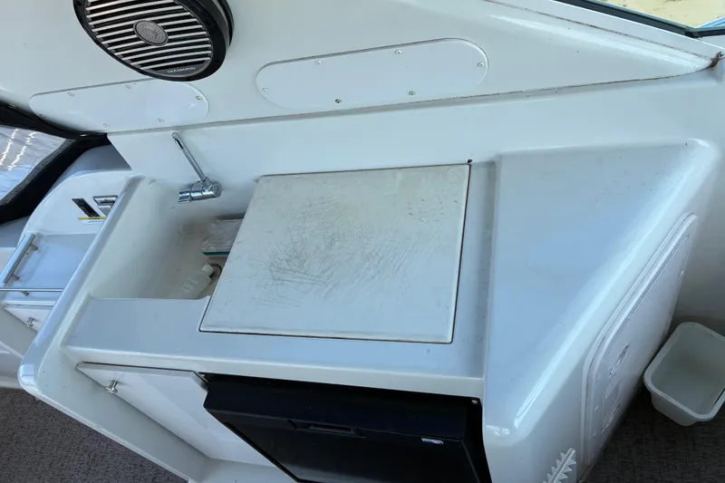 Slide: The Image of 1999 Trojan 360 Express yacht interior with sink, cutting board, and speaker. - 13