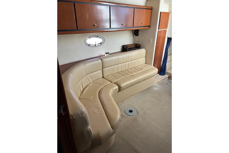 Slide: The Image of Interior of 1999 Trojan 360 Express yacht with beige leather seating and wooden cabinets. - 20