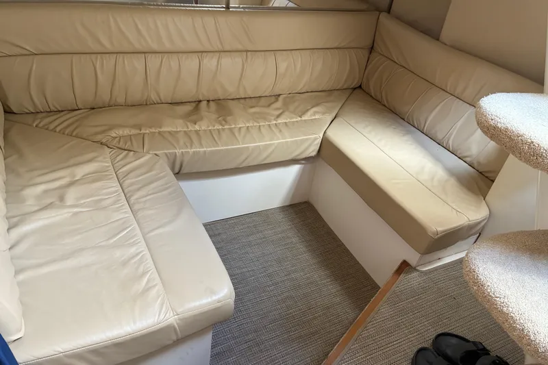 Slide: The Image of Interior of a 1999 Trojan 360 Express yacht with beige leather seating. - 21
