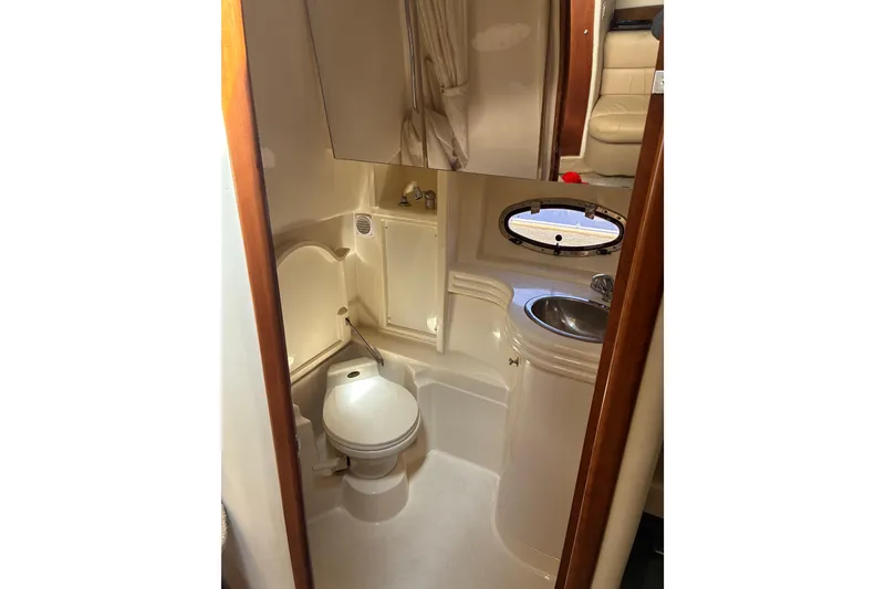 Slide: The Image of 1999 Trojan 360 Express yacht bathroom with toilet, sink, and mirror. - 22