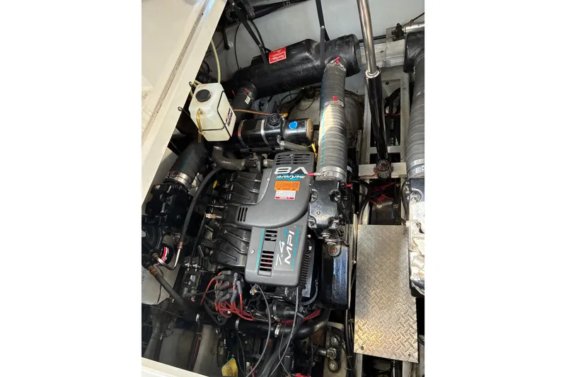Slide: The Image of Engine compartment of a 1999 Trojan 360 Express boat, featuring a V8 MPI engine. - 26