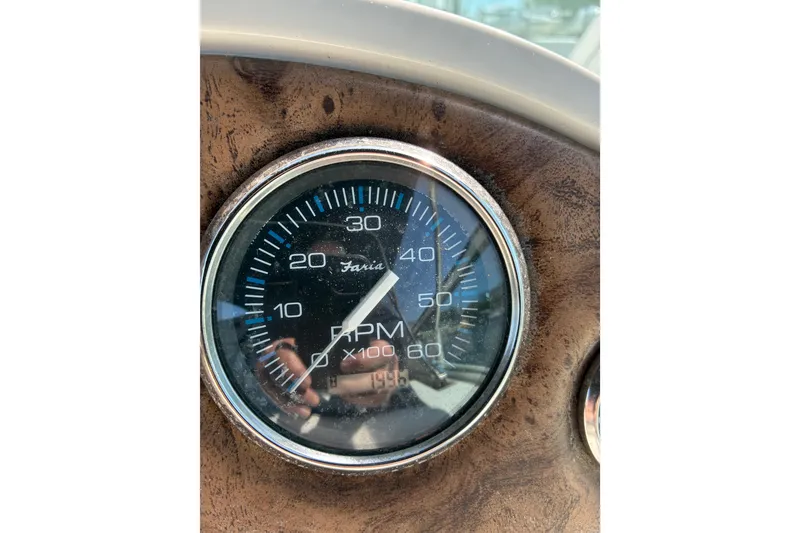 Slide: The Image of Close-up of a Faria RPM gauge on a 1999 Trojan 360 Express boat dashboard. - 28