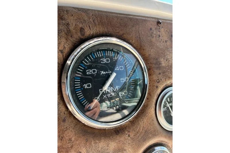 Slide: The Image of Close-up of a 1999 Trojan 360 Express RPM gauge on a wooden dashboard. - 29