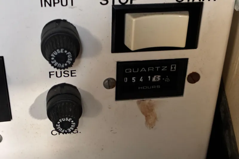 Slide: The Image of Control panel of a 1999 Trojan 360 Express with fuse knobs and hour meter. - 31