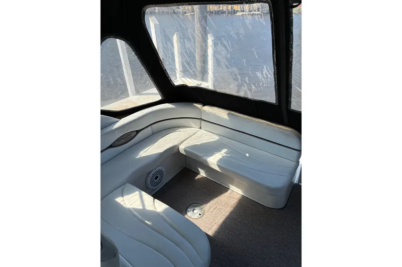 Slide: The Image of Interior of a 1999 Trojan 360 Express yacht with white seating and large windows. - 7