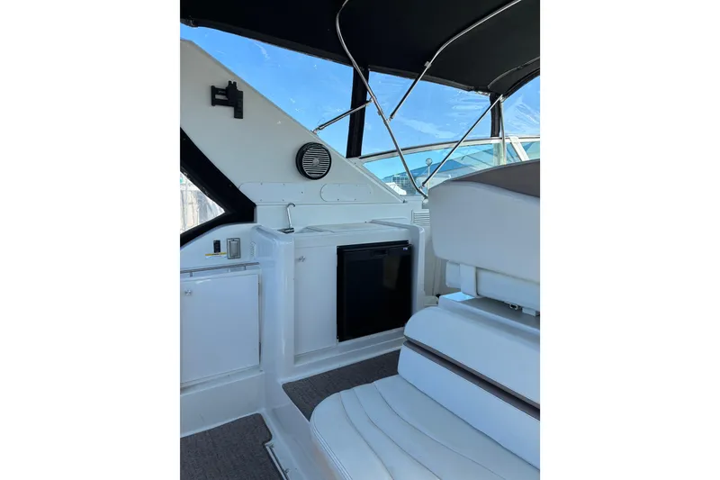 Slide: The Image of Interior of a 1999 Trojan 360 Express yacht, featuring seating and cabinetry. - 8