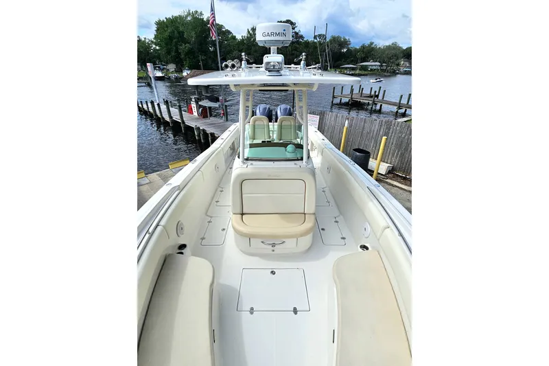 Slide: The Image of 2008 Chris-Craft Catalina 29 boat docked, featuring spacious seating and Garmin navigation system. - 12