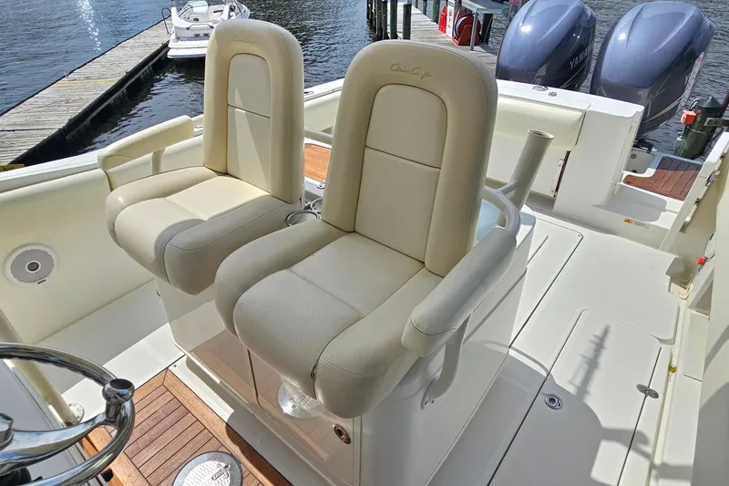 Slide: The Image of 2008 Chris-Craft Catalina 29 boat interior with beige seats and dual Yamaha engines. - 16