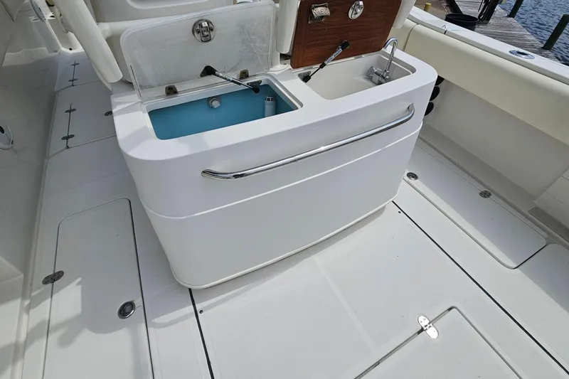 Slide: The Image of 2008 Chris-Craft Catalina 29 boat interior with sink and storage compartments. - 21