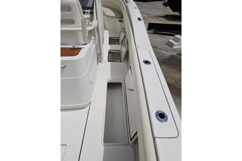 Slide: The Image of 2008 Chris-Craft Catalina 29 boat deck with storage compartments and seating area. - 24