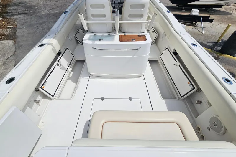 Slide: The Image of 2008 Chris-Craft Catalina 29 boat interior with white seating and storage compartments. - 25