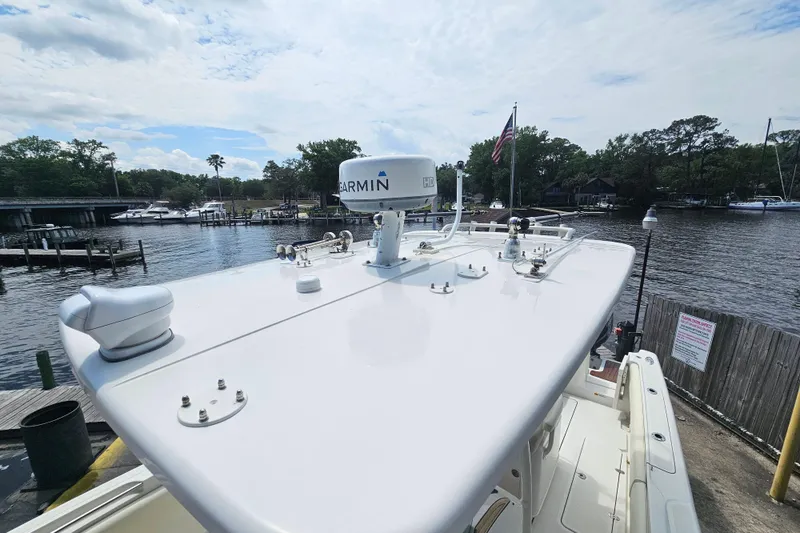 Slide: The Image of 2008 Chris-Craft Catalina 29 boat with Garmin radar, docked by a scenic waterfront. - 29
