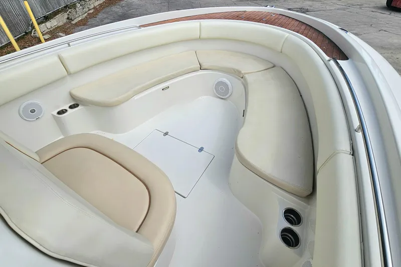Slide: The Image of 2008 Chris-Craft Catalina 29 boat interior with cushioned seating and speakers. - 9