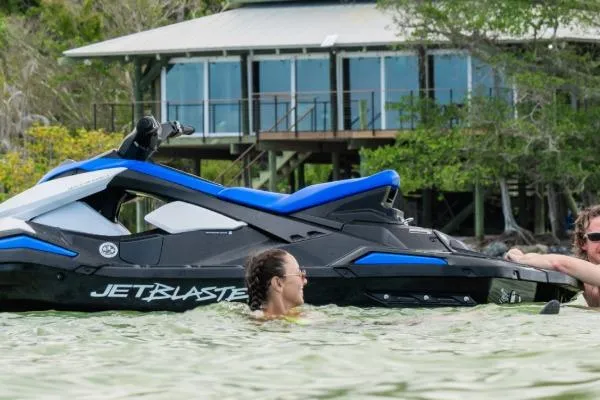 Slide: The Image of 2025 Yamaha WaveRunner JetBlaster on water near a modern lakeside house. - 10