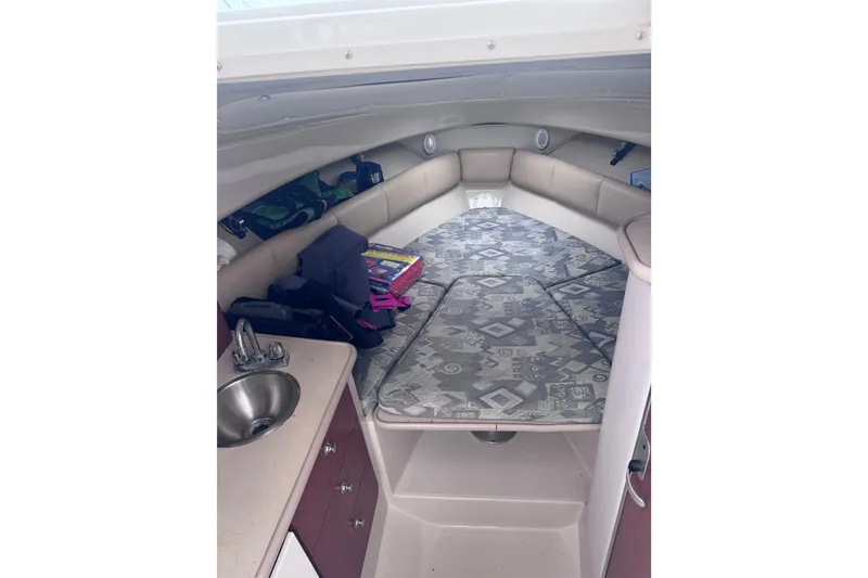 Slide: The Image of 2003 Robalo R265 Walkaround cabin interior with patterned cushions and compact sink. - 11