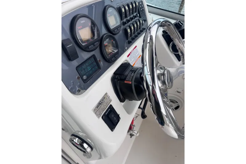 Slide: The Image of 2003 Robalo R265 Walkaround dashboard with gauges and steering wheel. - 5